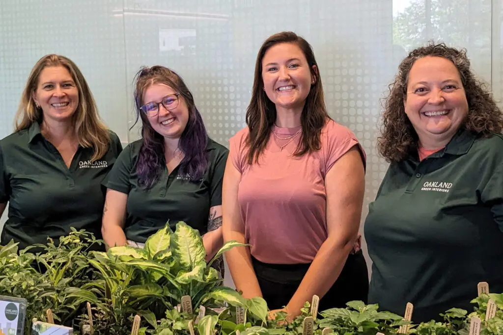 Team Members of Oakland Green Interiors with Indoor Plants in Columbus, OH