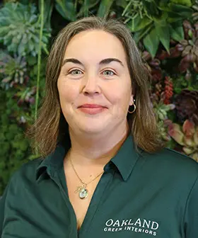 Jamie Neu, horticultural technician, smiling at Oakland Green Interiors in Columbus, OH