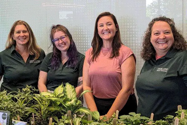 Oakland Green Interiors team at an industry event with greenery in Columbus, OH