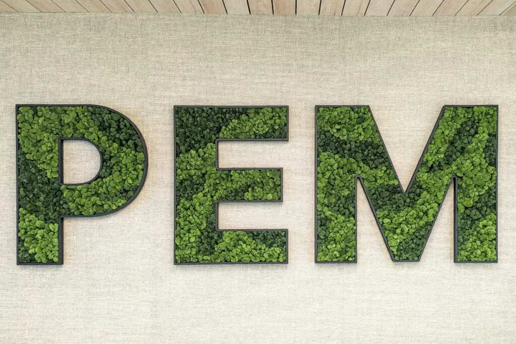 Custom moss wall logo showcasing brand identity in modern office design, Columbus, OH

